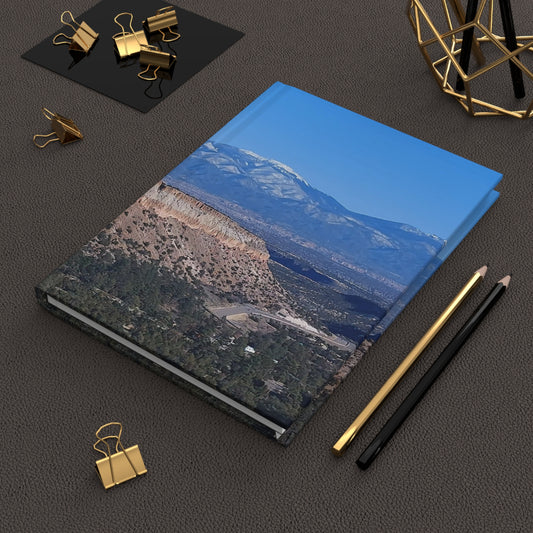 A Hardcover Journal Matte depicting NM Mountains